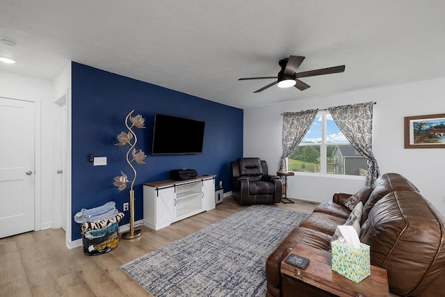 1118 E Lakota St, Nixa, MO 65714 - living room featuring ceiling fan, light wood-style floors, and baseboards