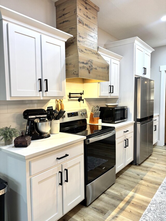 2702 Town Dr, Mountain Grove, MO 65711 - kitchen with stainless steel appliances, light wood-style floors, light countertops, and white cabinets