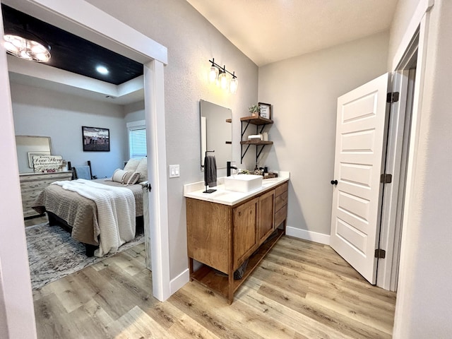 2702 Town Dr, Mountain Grove, MO 65711 - full bath with ensuite bathroom, wood finished floors, double vanity, and baseboards