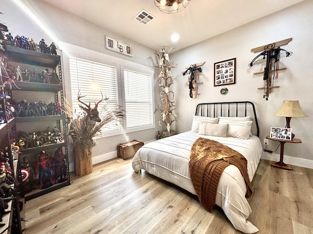 2702 Town Dr, Mountain Grove, MO 65711 - bedroom featuring baseboards and wood finished floors