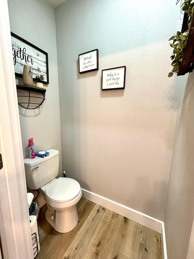2702 Town Dr, Mountain Grove, MO 65711 - bathroom featuring wood finished floors, toilet, and baseboards