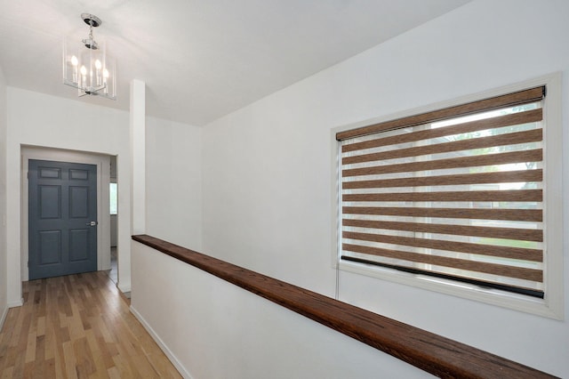 11976 N Northern Hts Dr, Brighton, MO 65617 - hall featuring light wood-type flooring, a chandelier, baseboards, and an upstairs landing