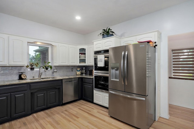 11976 N Northern Hts Dr, Brighton, MO 65617 - kitchen with stainless steel appliances, a sink, white cabinetry, and light stone counters