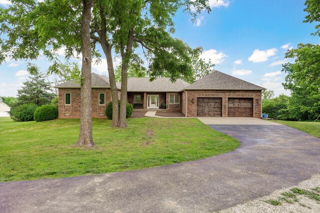 11976 N Northern Hts Dr, Brighton, MO 65617 - ranch-style home with an attached garage, driveway, brick siding, and a front lawn