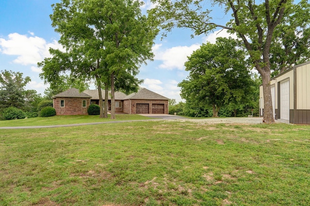 11976 N Northern Hts Dr, Brighton, MO 65617 - view of grassy yard featuring a garage and driveway