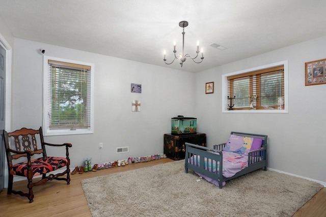 11976 N Northern Hts Dr, Brighton, MO 65617 - bedroom featuring a chandelier, light wood-style floors, and multiple windows