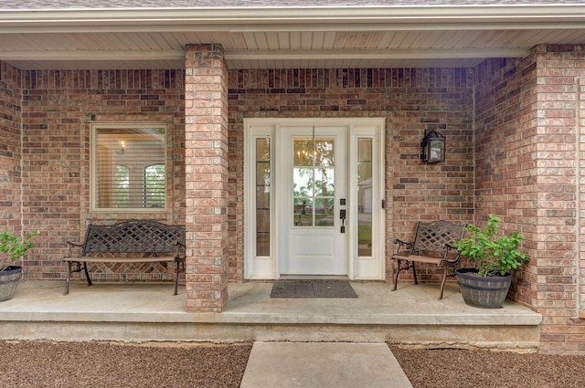 11976 N Northern Hts Dr, Brighton, MO 65617 - doorway to property featuring a porch, brick siding, and a shingled roof