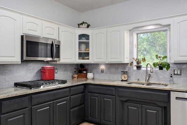 11976 N Northern Hts Dr, Brighton, MO 65617 - kitchen with stainless steel appliances, a sink, white cabinets, and tasteful backsplash