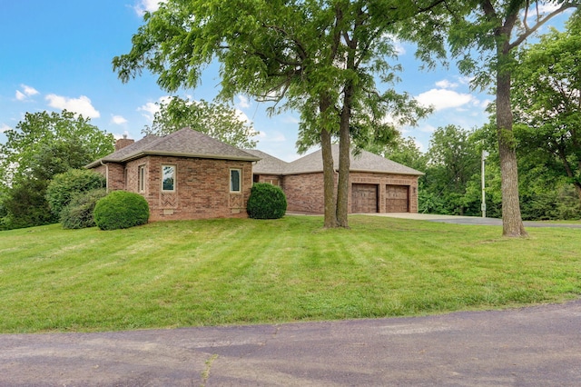 11976 N Northern Hts Dr, Brighton, MO 65617 - view of front of house featuring driveway, brick siding, a chimney, an attached garage, and a front lawn