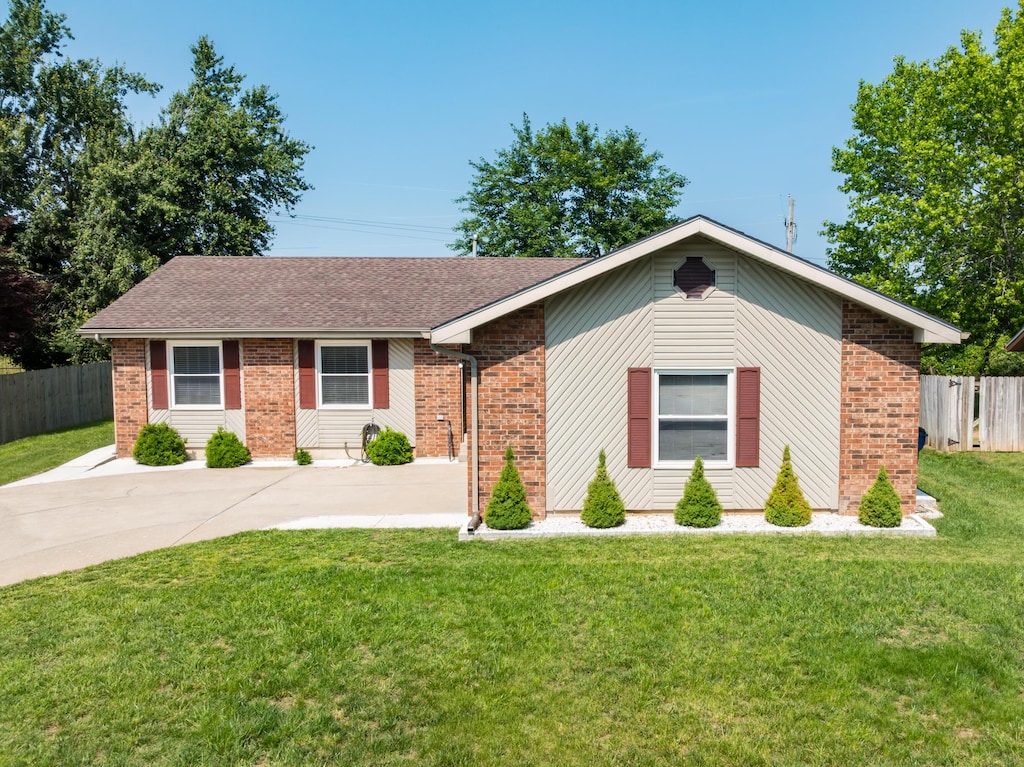 711 S Eagle St, Nixa, MO 65714 - ranch-style home with brick siding, roof with shingles, and driveway