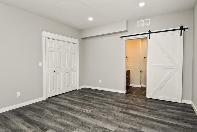 111 S Mill St, Rogersville, MO 65742 - unfurnished bedroom with a barn door, recessed lighting, dark wood finished floors, baseboards, and a closet