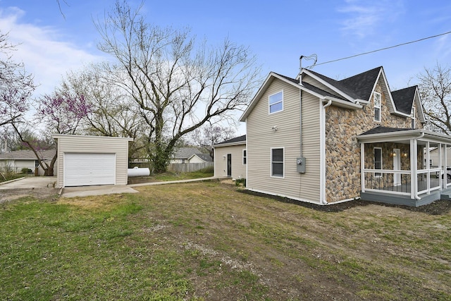 111 S Mill St, Rogersville, MO 65742 - view of home's exterior with stone siding, a garage, driveway, an outbuilding, and a sunroom