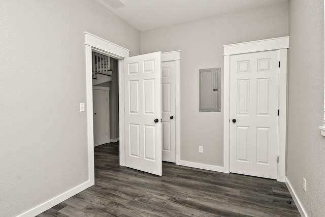 111 S Mill St, Rogersville, MO 65742 - unfurnished bedroom featuring electric panel, dark wood finished floors, and baseboards