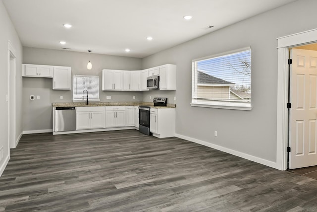 111 S Mill St, Rogersville, MO 65742 - kitchen with stainless steel appliances, baseboards, a sink, white cabinets, and recessed lighting