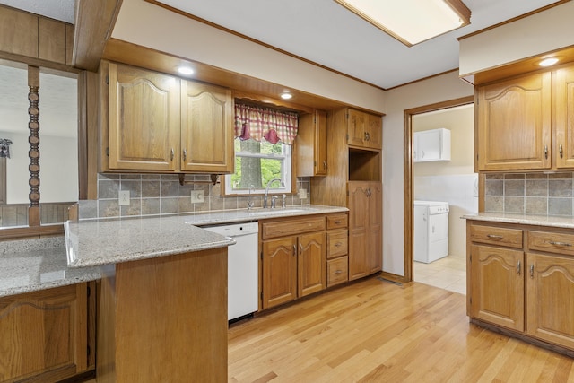 5263 N Crestwood Dr, Springfield, MO 65803 - kitchen with dishwasher, tasteful backsplash, light wood finished floors, washer and dryer, and brown cabinetry
