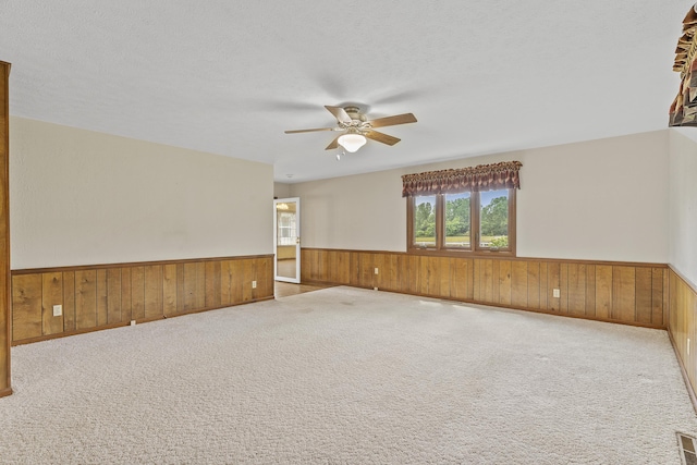 5263 N Crestwood Dr, Springfield, MO 65803 - carpeted spare room with a wainscoted wall, ceiling fan, and wooden walls
