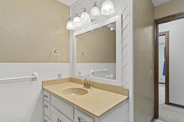 5263 N Crestwood Dr, Springfield, MO 65803 - bathroom with a textured wall, vanity, and tile walls
