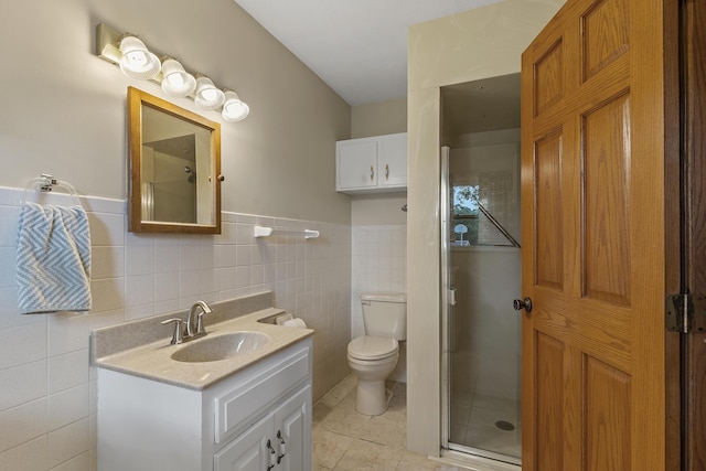 5263 N Crestwood Dr, Springfield, MO 65803 - full bathroom featuring vanity, tile walls, an enclosed shower, tile patterned floors, and wainscoting