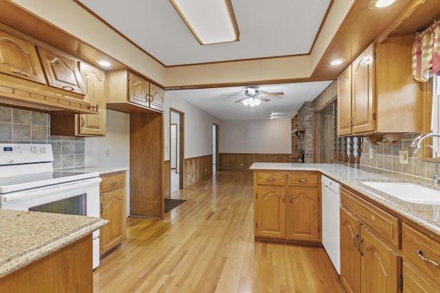 5263 N Crestwood Dr, Springfield, MO 65803 - kitchen with white appliances, a peninsula, wainscoting, a ceiling fan, and light wood-style floors
