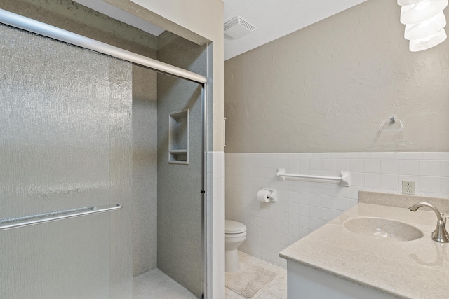 5263 N Crestwood Dr, Springfield, MO 65803 - full bath with vanity, tile walls, a shower stall, and a wainscoted wall
