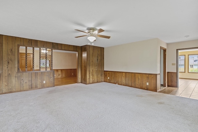 5263 N Crestwood Dr, Springfield, MO 65803 - carpeted empty room featuring wood walls and a ceiling fan