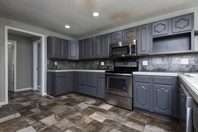 5364 Cloverdale Ln, Battlefield, MO 65619 - kitchen with appliances with stainless steel finishes, gray cabinets, tasteful backsplash, baseboards, and recessed lighting