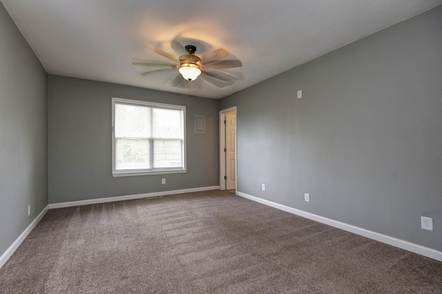 5364 Cloverdale Ln, Battlefield, MO 65619 - empty room featuring ceiling fan, baseboards, and dark carpet