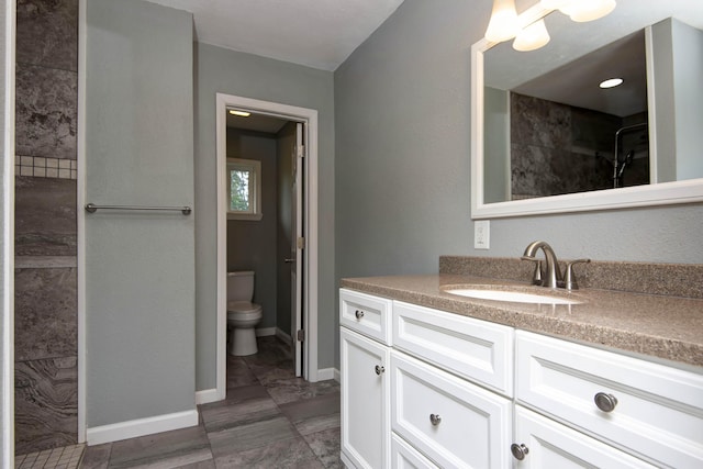 5364 Cloverdale Ln, Battlefield, MO 65619 - bathroom featuring vanity, toilet, baseboards, and a shower