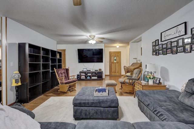 1631 Robertson Ave, Carthage, MO 64836 - living area with a ceiling fan, wood finished floors, and a textured ceiling