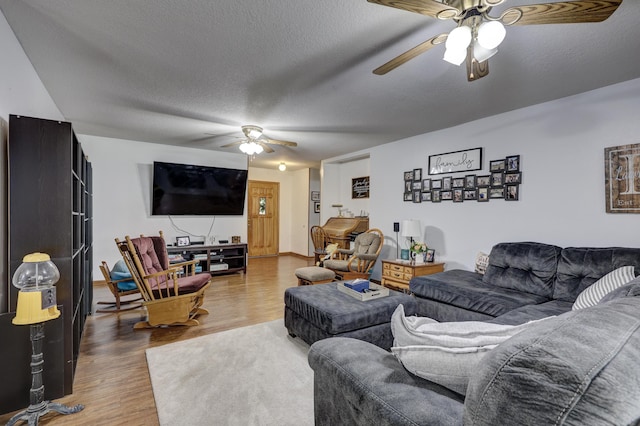 1631 Robertson Ave, Carthage, MO 64836 - living room featuring ceiling fan, wood finished floors, and a textured ceiling