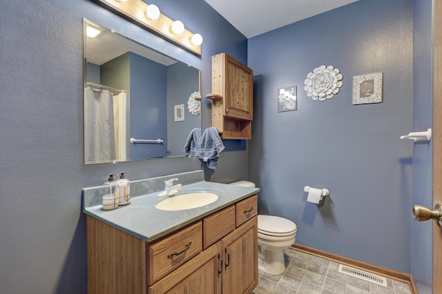 1631 Robertson Ave, Carthage, MO 64836 - full bathroom with vanity, toilet, baseboards, and a shower with shower curtain