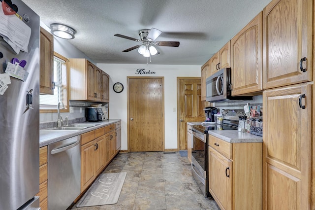 1631 Robertson Ave, Carthage, MO 64836 - kitchen featuring appliances with stainless steel finishes, a sink, a ceiling fan, light countertops, and a textured ceiling