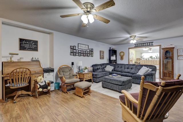 1631 Robertson Ave, Carthage, MO 64836 - living room with ceiling fan, a textured ceiling, and light wood-type flooring