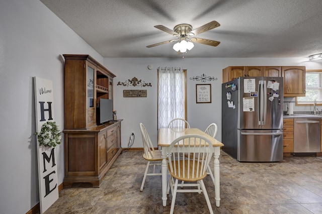 1631 Robertson Ave, Carthage, MO 64836 - dining area with a textured ceiling, a ceiling fan, and baseboards