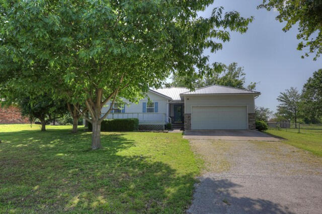 1631 Robertson Ave, Carthage, MO 64836 - ranch-style house with gravel driveway, an attached garage, stone siding, and metal roof