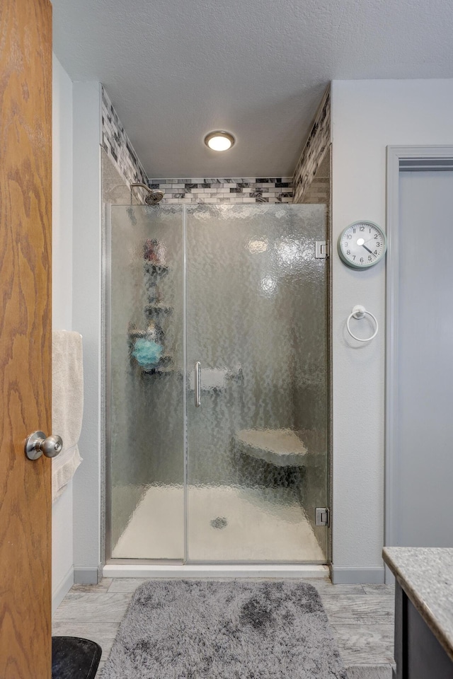 1631 Robertson Ave, Carthage, MO 64836 - full bath with a stall shower, vanity, and baseboards