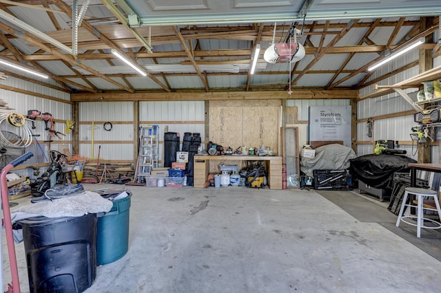 1631 Robertson Ave, Carthage, MO 64836 - garage with a garage door opener, metal wall, and a workshop area
