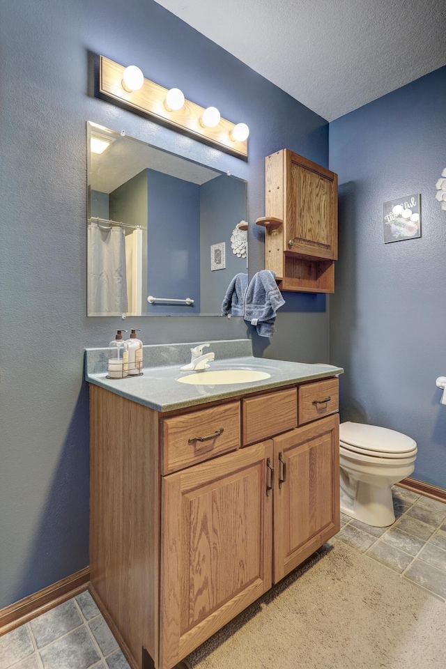 1631 Robertson Ave, Carthage, MO 64836 - full bath with vanity, toilet, and baseboards