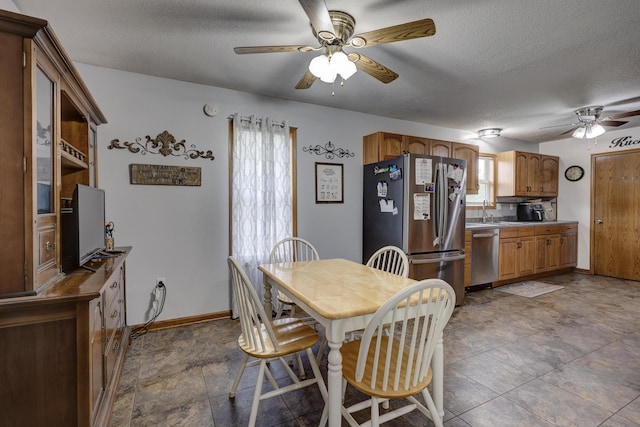 1631 Robertson Ave, Carthage, MO 64836 - dining room featuring ceiling fan, a textured ceiling, and baseboards