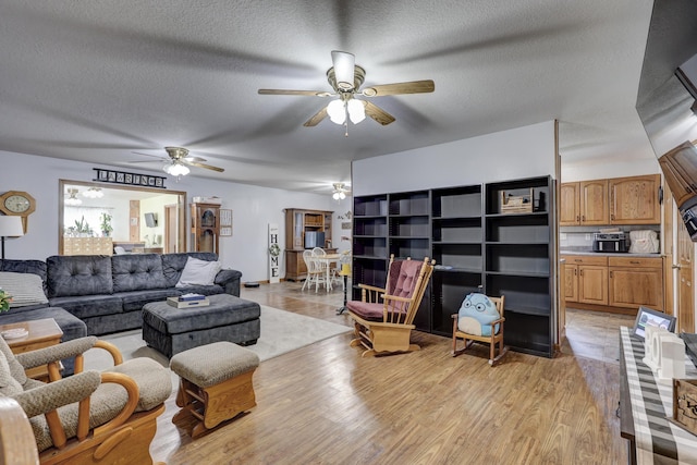 1631 Robertson Ave, Carthage, MO 64836 - living area featuring ceiling fan, a textured ceiling, and light wood-style floors