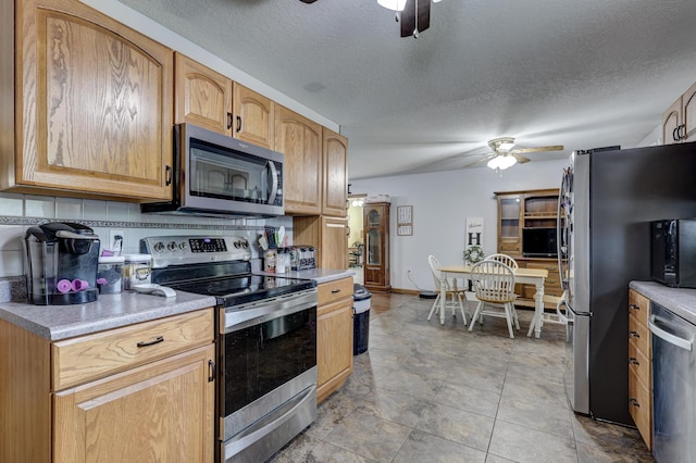 1631 Robertson Ave, Carthage, MO 64836 - kitchen with stainless steel appliances, ceiling fan, a textured ceiling, and light countertops