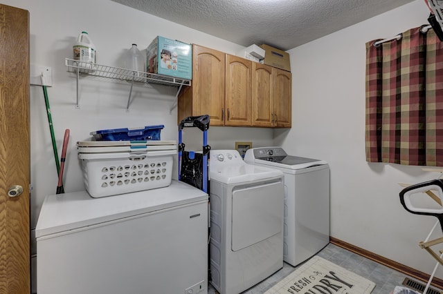 1631 Robertson Ave, Carthage, MO 64836 - washroom with washing machine and clothes dryer, cabinet space, a textured ceiling, and baseboards