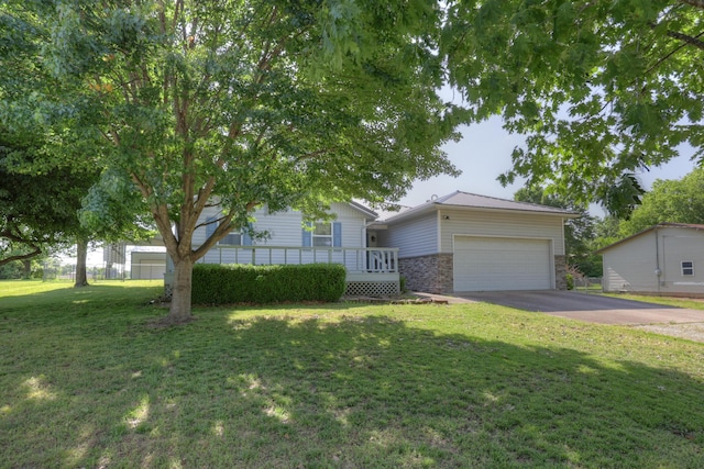 1631 Robertson Ave, Carthage, MO 64836 - view of front of home with stone siding, concrete driveway, a garage, and a front lawn