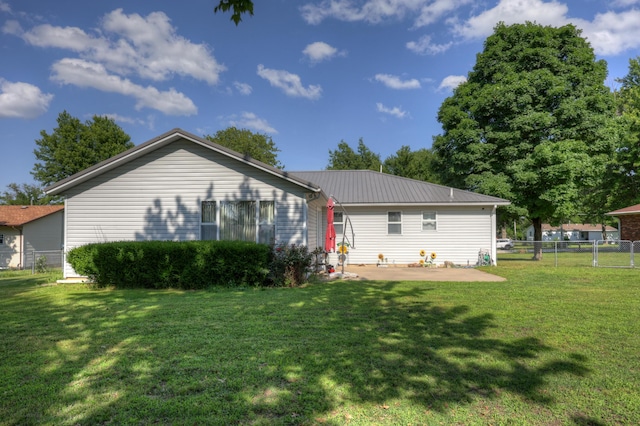 1631 Robertson Ave, Carthage, MO 64836 - rear view of property featuring a patio and metal roof