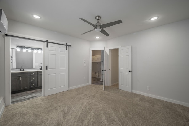 2339 Xenia St, Joplin, MO 64801 - unfurnished bedroom with a barn door, carpet floors, connected bathroom, recessed lighting, and ceiling fan