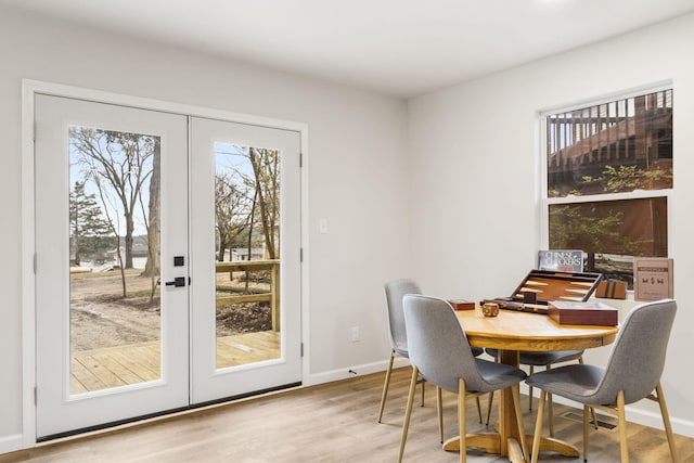 3050 Montague Ln, Kimberling City, MO 65686 - dining area featuring french doors, plenty of natural light, wood finished floors, and baseboards