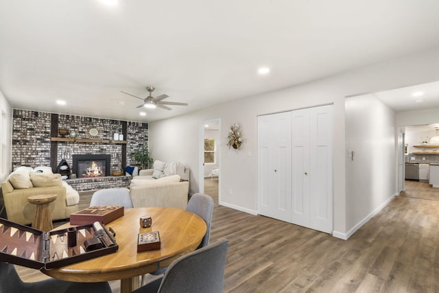 3050 Montague Ln, Kimberling City, MO 65686 - living area with wood finished floors, a ceiling fan, a brick fireplace, recessed lighting, and baseboards