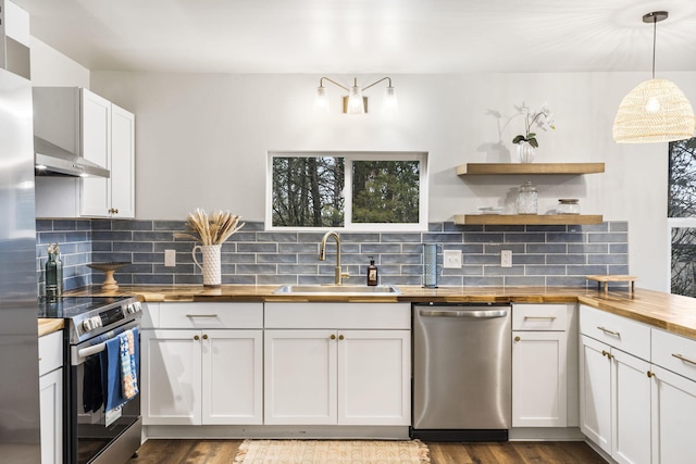 3050 Montague Ln, Kimberling City, MO 65686 - kitchen with wooden counters, stainless steel appliances, a sink, dark wood-style floors, and backsplash