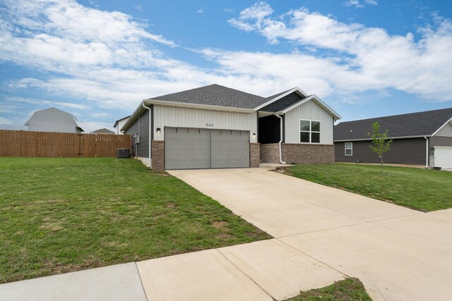 565 S Michelle Ave, Republic, MO 65738 - view of front facade featuring an attached garage, brick siding, central AC, and concrete driveway