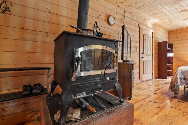 447 Flint Ln, Washburn, MO 65772 - detailed view of wooden walls, wood finished floors, a wood stove, and wooden ceiling